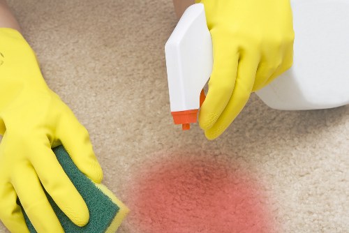 Domestic cleaner working in a London apartment kitchen