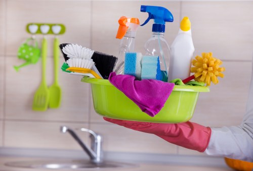 Professional cleaner tidying a kitchen in a London home