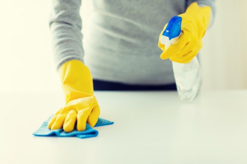 Local carpet cleaner treating stains in a London office corridor
